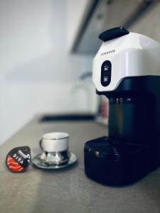 a coffee maker sitting on a counter next to a mortar and pestle at Suite Apartment a tema Natale in centro storico "Gingerbread Suite" in Chioggia