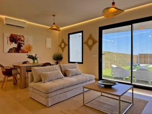 a living room with a couch and a table at Casa Las Mironas II - Ole Solutions in El Puerto de Santa María