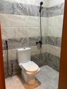 a bathroom with a toilet and a shower at استديو مميز بدخول ذاتي in Jeddah +6 photos