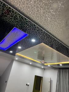 a ceiling in a room with blue lights on it at Shri Jagannath Palace Hotel in Jaipur