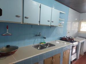 a kitchen with a sink and a stove at Encarnacion House in Encarnación