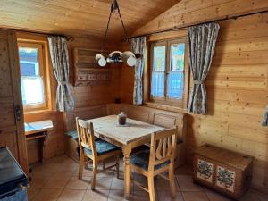 a dining room with a wooden table and chairs at Ferienwohnung Top 5 in Altmünster