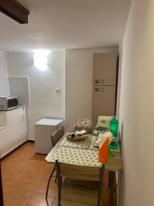a small kitchen with a table and a small refrigerator at I Tramonti del Salento in Gallipoli