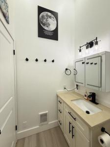 a bathroom with a sink and a mirror at Modern 3BR Townhouse near UW in Seattle