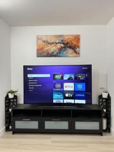 a large flat screen tv in a living room at Modern 3BR Townhouse near UW in Seattle