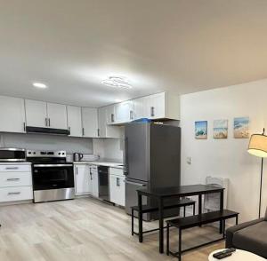 a kitchen with white cabinets and a table in a room at Modern 3BR Townhouse near UW in Seattle +19 photos