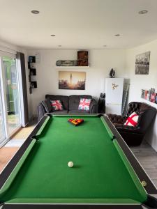 a living room with a green pool table at The Green Bus and the lodge in Woodstock