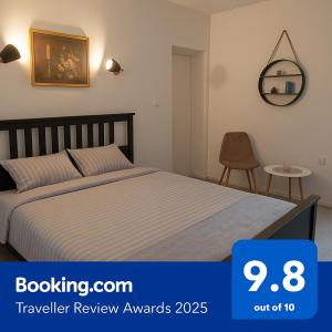 a bedroom with a bed and a table with a chair at Apartment F.R.I.E.N.D.S in Paraćin