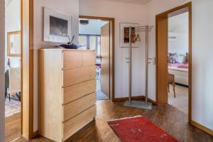 a living room with a dresser and a mirror at Dreiländereck in Hartheim