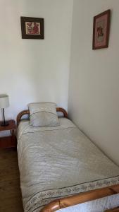 a small bed in a corner of a bedroom at Petite maison de brocanteur à Charbonnières in Charbonnières-les-Bains +7 photos
