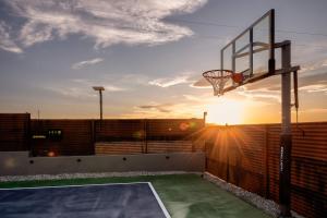 a basketball hoop on a balcony with the sunset at Pool-Pickleball-YogaDeck in Joshua Tree