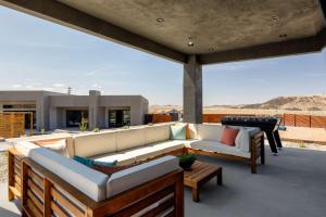 a living room with a couch and tables on a patio at Pool-Pickleball-YogaDeck in Joshua Tree