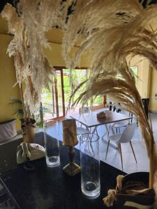 a table with three glass vases on it with a table with a tableablish at Eco hotel Torino in Tarso
