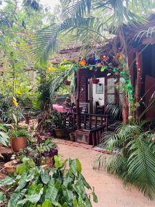 a garden with a bench and many plants at Sigiri Niwahana Home Stay in Sigiriya