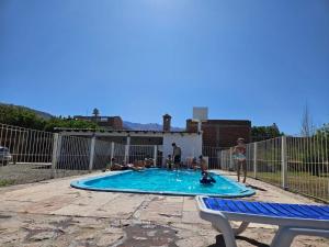 a group of people playing in a swimming pool at Cafayate Deptos in Cafayate
