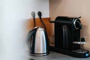 a coffeemaker and coffee maker on a kitchen counter at Grand Prix Appartement Spielberg, Self Check-in in Zeltweg