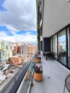 a balcony of a building with a view of a city at Panoramic Terrace ESSENCE Luxury Suite in Carolina Park in Quito