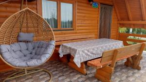 a porch with a swing and a table and a chair at Brvnara N&N in Laktaši +52 photos