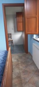 a kitchen with wooden cabinets and a tile floor at Agriturismo le Cammarose in Felitto