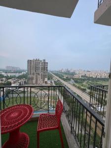 a patio with a table and chairs on a balcony at Heavenly stays in Greater Noida