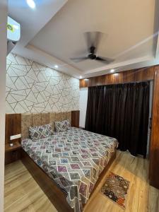 a bedroom with a bed and a ceiling fan at Heavenly stays in Greater Noida