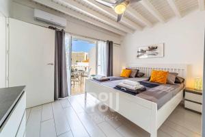 a white bedroom with a bed and a balcony at Apartment Paraiso Royal in Arona +79 photos