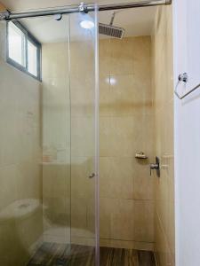 a shower with a glass door in a bathroom at Riviere 619 in Ríohacha