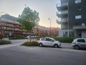 a white car parked on the side of a street at University House in Örebro