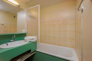 a bathroom with a tub and a sink and a shower at Ski In-Out - Heart of Val Thorens Great 6 Guests, WiFi 20 in Val Thorens +3 photos