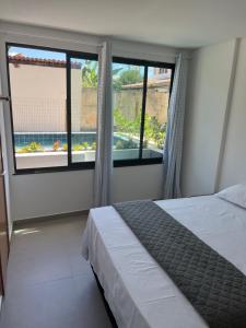 Ένα ή περισσότερα κρεβάτια σε δωμάτιο στο Flat Beira Mar Maracaípe- Porto de Galinhas +50 φωτογραφίες