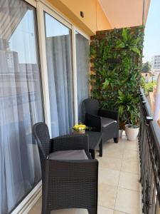a balcony with chairs and a table on a balcony at Lux Apartman David Dobra voda in Bar