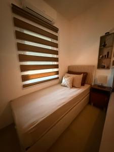 a bed in a room with a large window at Lux Apartman David Dobra voda in Bar