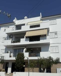 a white building with windows and plants on it at La Vie Royale in Nicosia