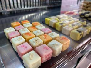 a bunch of different colored cakes on a display case at Casa Bors in Riva del Garda
