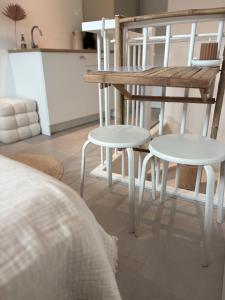 a table and two chairs in a living room at Studio No3 in Katwijk aan Zee +13 photos