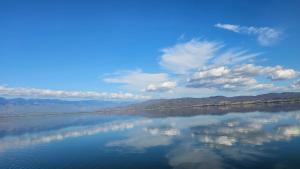 a large body of water with a blue sky and clouds at LAKE Dream 1 in Star Dojran +19 photos