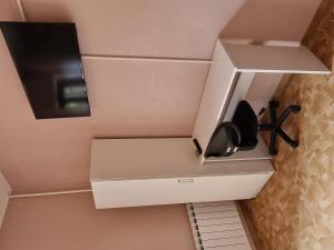 a kitchen with white cabinets and a black speaker at D&D rooms 5 in Pula