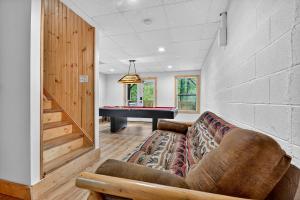 a living room with a couch and a pool table at New Alpenrosen Haus-Arcade Hot Tub Sauna Views in Helen