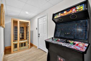 a video game console in a room with a game at New Mtn&City Views Hot Tub Sauna Arcade Pool in Helen