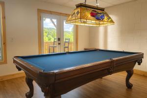a pool table in a room with a chandelier at New Mtn&City Views Hot Tub Sauna Arcade Pool in Helen