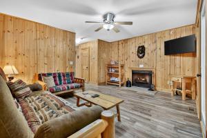 a living room with a couch and a fireplace at New Mtn&City Views Hot Tub Sauna Arcade Pool in Helen