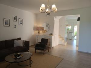 a living room with a couch and a table at Albina's luxury Villa 3 bedroom in Hanioti
