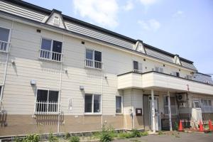 a large white building with windows on the side of it at Minpakushisetsu Nipopo - Vacation STAY 19576 in Fukagawa