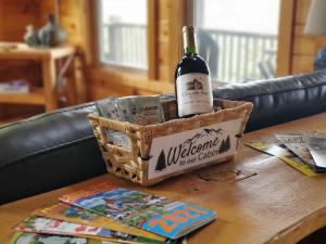 a bottle of wine in a basket on a table at New The Hummingbird - MtnViews Hot Tub Game Room in Sautee Nacoochee