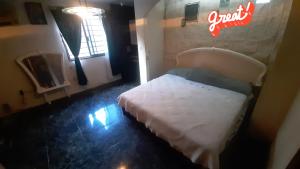 a bedroom with a bed and a neon sign on the wall at Castillo de Mario in Cancún