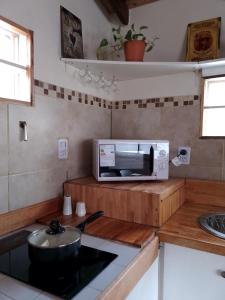 a kitchen with a microwave and a sink at Casa Montanara in El Chalten +9 photos