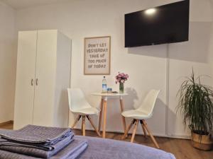 een kamer met 2 stoelen en een tafel met een tv bij Ferienwohnung Aurelia in Bad Reichenhall
