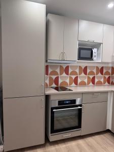 a kitchen with a refrigerator and a microwave at Appartement Cosy Bord de mer in Le Pradet