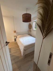 a small bedroom with a bed and a window at Appartement Cosy Bord de mer in Le Pradet