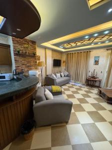 a large living room with a checkered floor at La Sirena Villa for Families only in Ain Sokhna